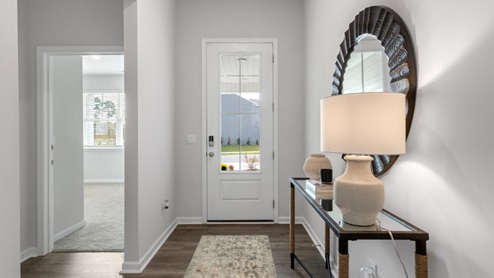 The Litchfield plan is a perfect home for beach living and entertaining. Completely open floor plan, 11-foot-high ceiling, and a large gourmet kitchen