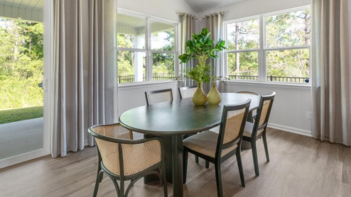 large gourmet kitchen with 36'' staggered cabinets with crown molding, granite, tile backsplash, walk-in pantry, and stainless-steel appliances in kitchen.