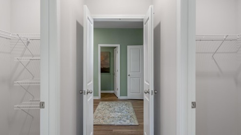 . The primary suite features a step-in 5-foot shower and dual vanity. 4 panel glass sliding doors open onto large covered porch