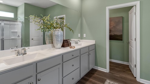. The primary suite features a step-in 5-foot shower and dual vanity. 4 panel glass sliding doors open onto large covered porch