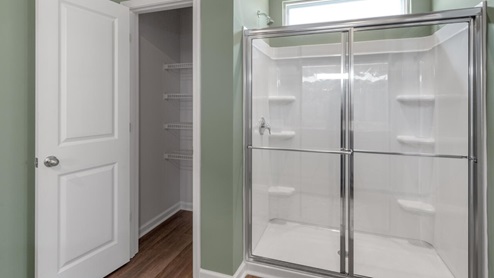 . The primary suite features a step-in 5-foot shower and dual vanity. 4 panel glass sliding doors open onto large covered porch
