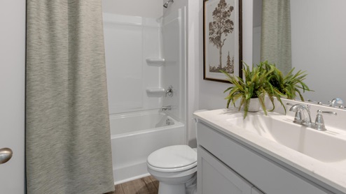. The primary suite features a step-in 5-foot shower and dual vanity. 4 panel glass sliding doors open onto large covered porch