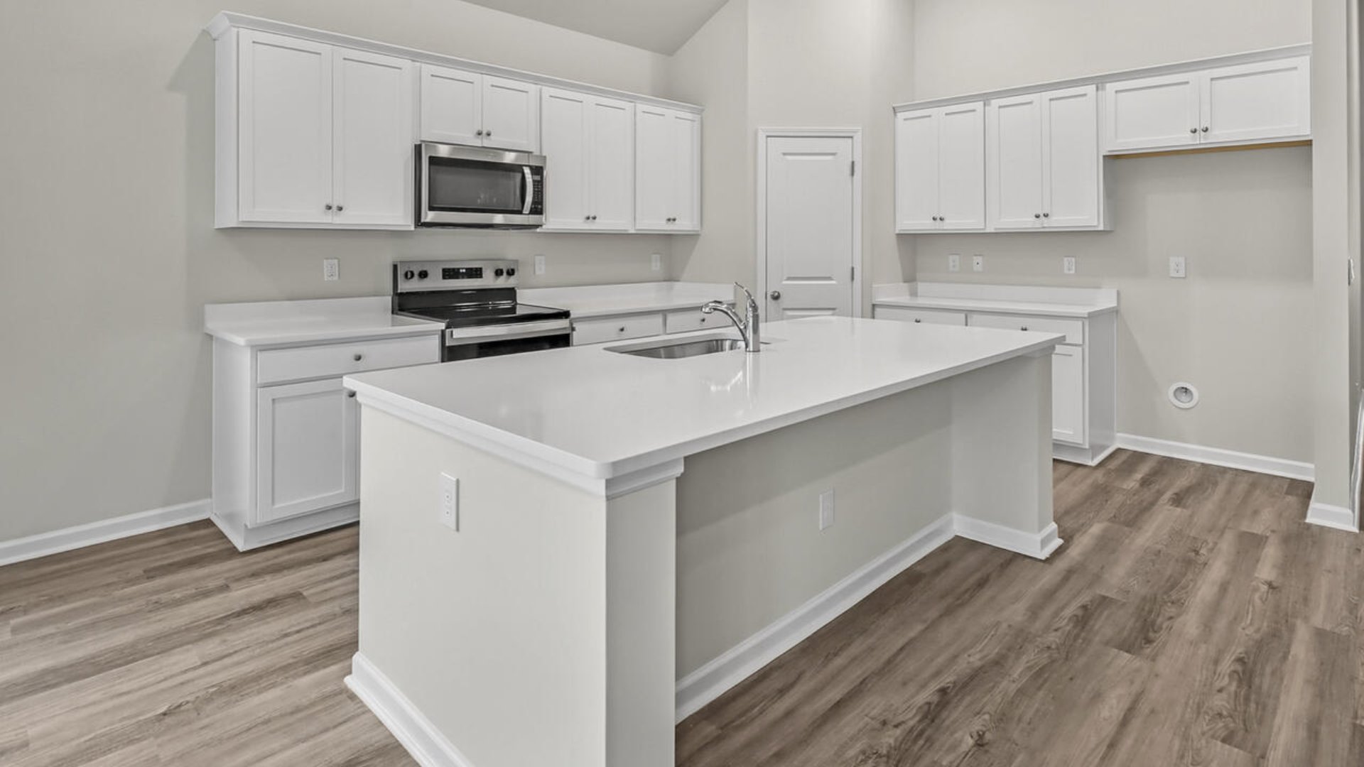a large gourmet kitchen with 42'' cabinets and granite, walk-in pantry, and stainless-steel appliances in kitchen.