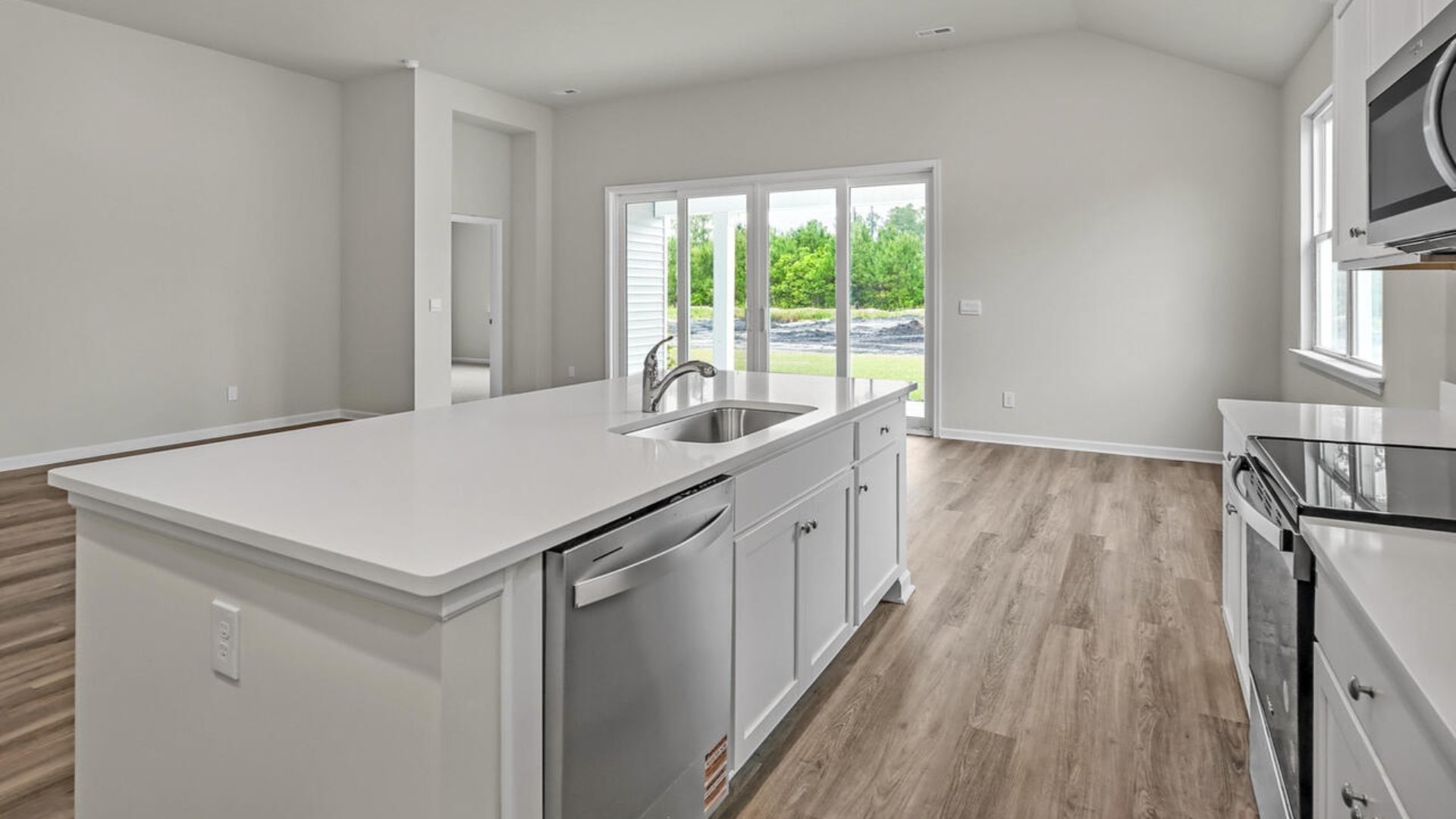 a large gourmet kitchen with 42'' cabinets and granite, walk-in pantry, and stainless-steel appliances in kitchen.