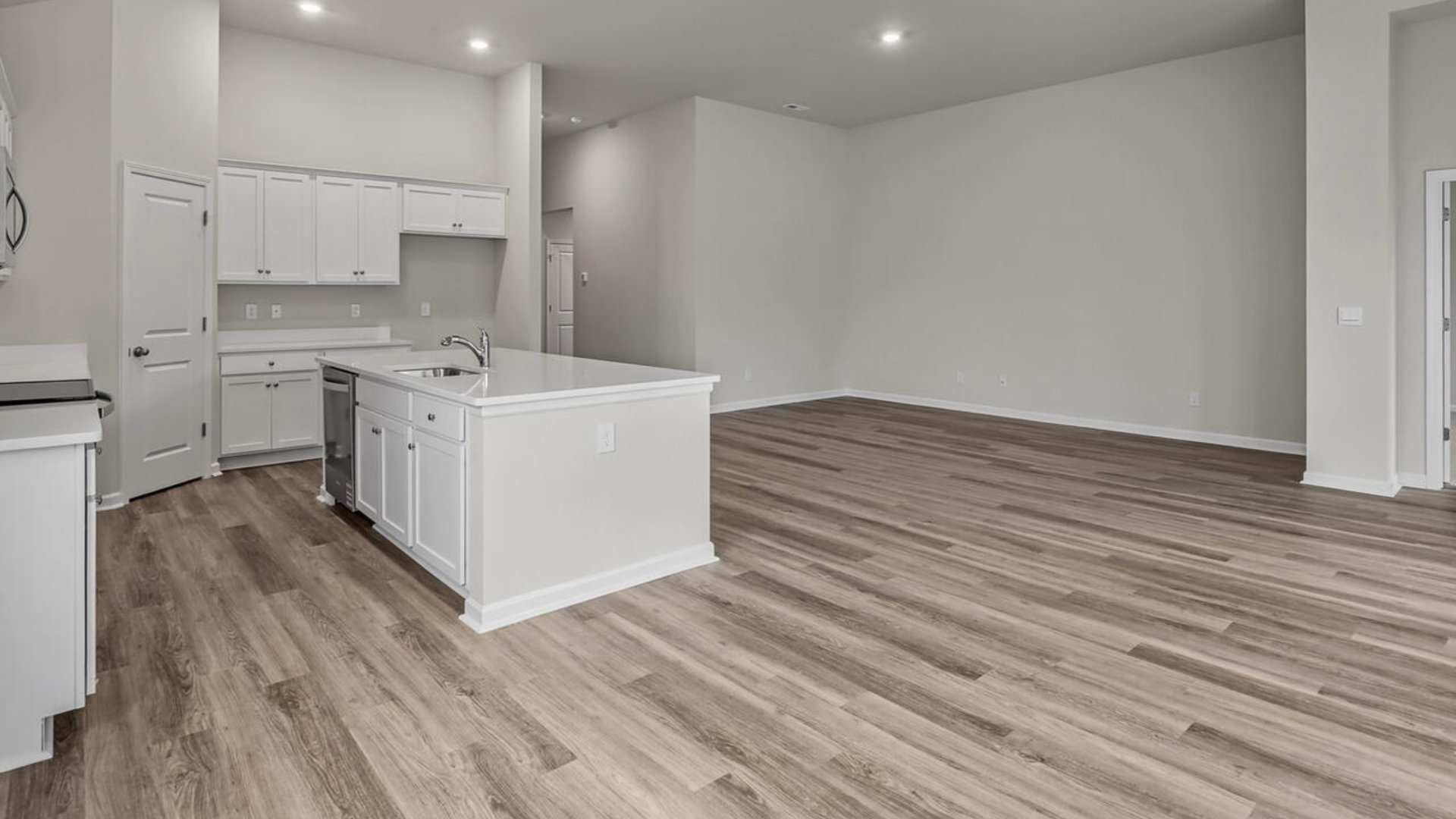 a large gourmet kitchen with 42'' cabinets and granite, walk-in pantry, and stainless-steel appliances in kitchen.