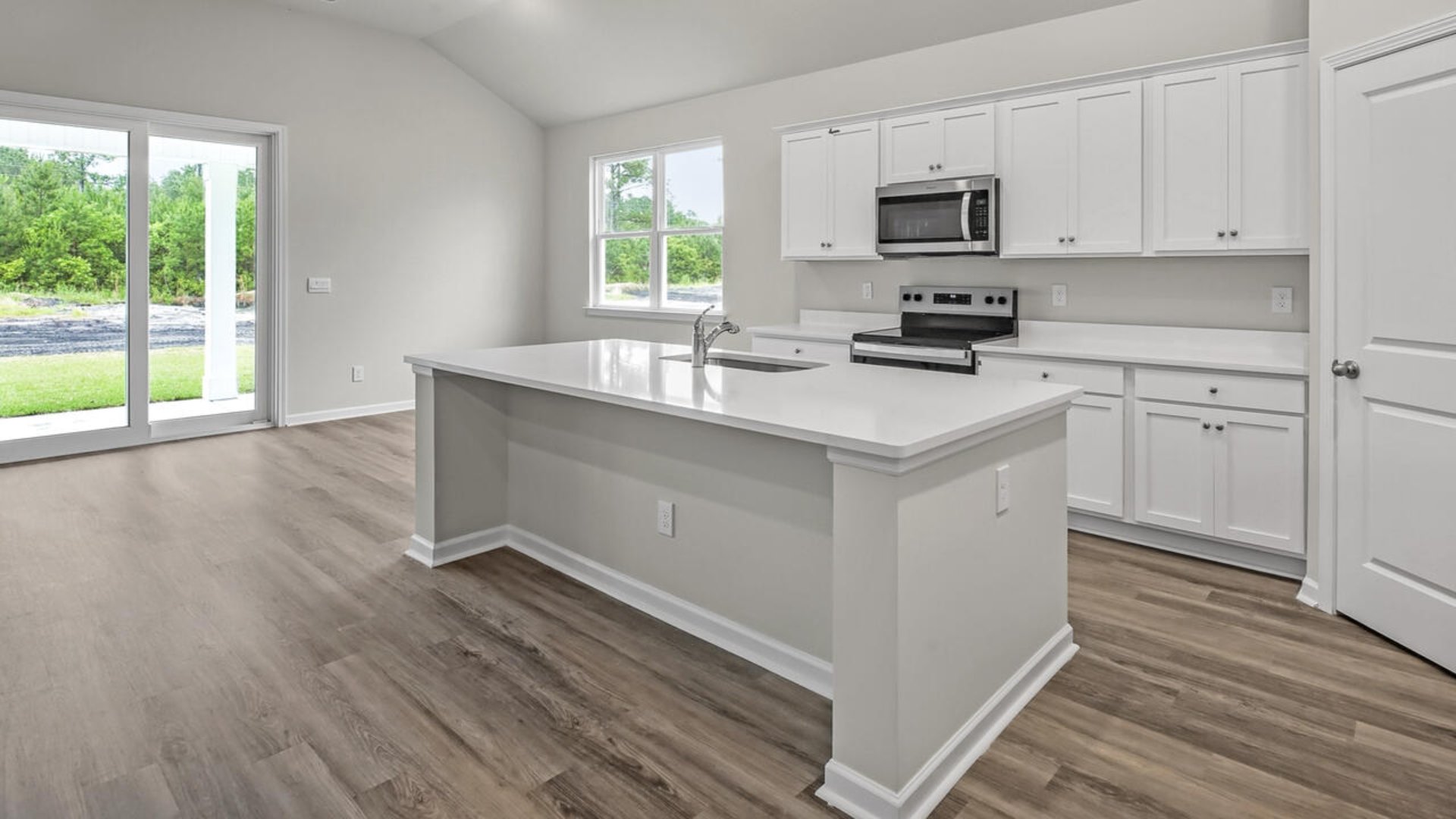 A large gourmet kitchen with 42'' cabinets and granite, walk-in pantry, and stainless-steel appliances in kitchen.