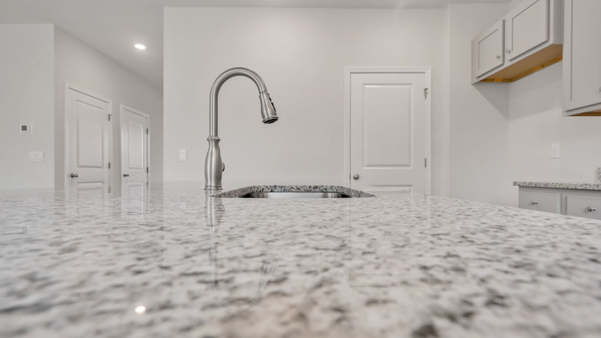 That's not all - the open-concept living room and kitchen are pure perfection, complete with granite countertops, 9' ceilings, and walk-in pantry. Oh, and did I mention it's a gas community with super-efficient tankless water heaters