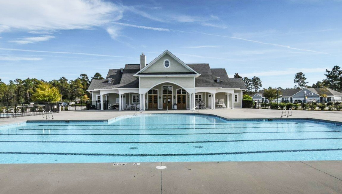 Homeowners have access to a range of amenities such as a well-equipped clubhouse, a fitness room, a spacious competition swimming pool, a kiddie pool, a hot tub, a sports court, a playground, and picturesque nature trails for walking.