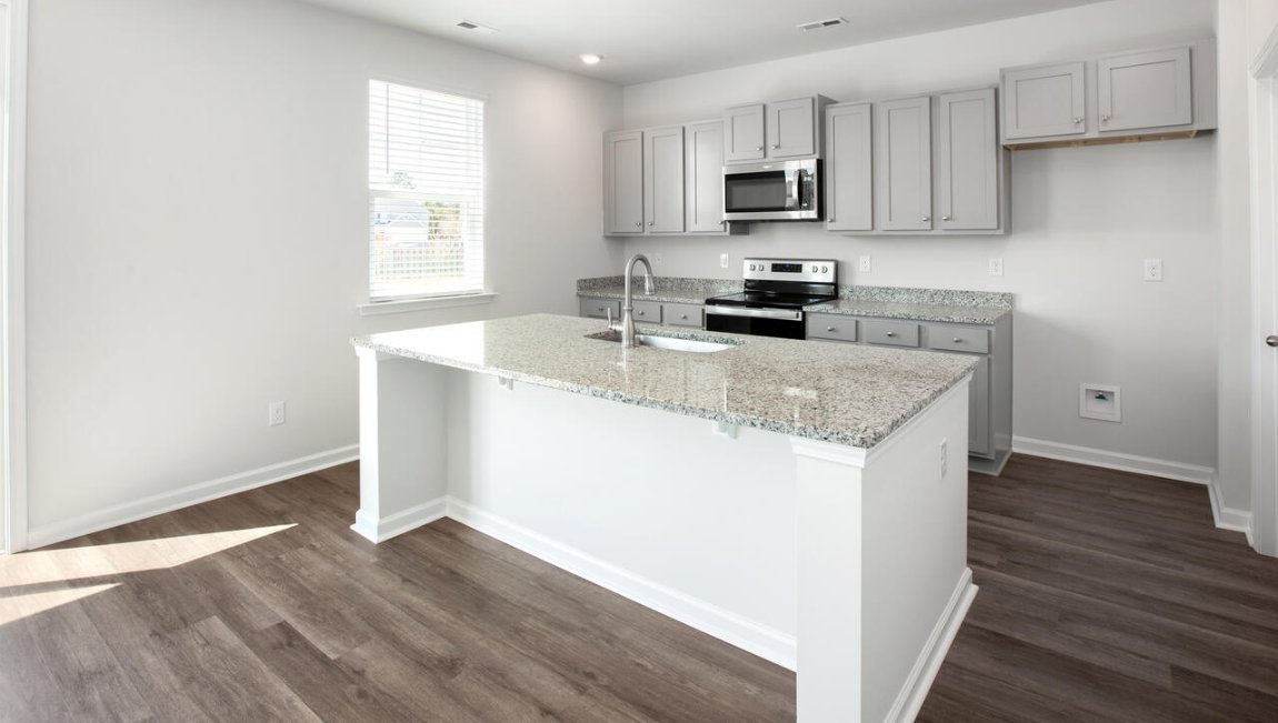 The kitchen features shaker-style cabinets, granite countertops, and stainless-steel appliances, which are sure to both turn heads and make meal prep easy.