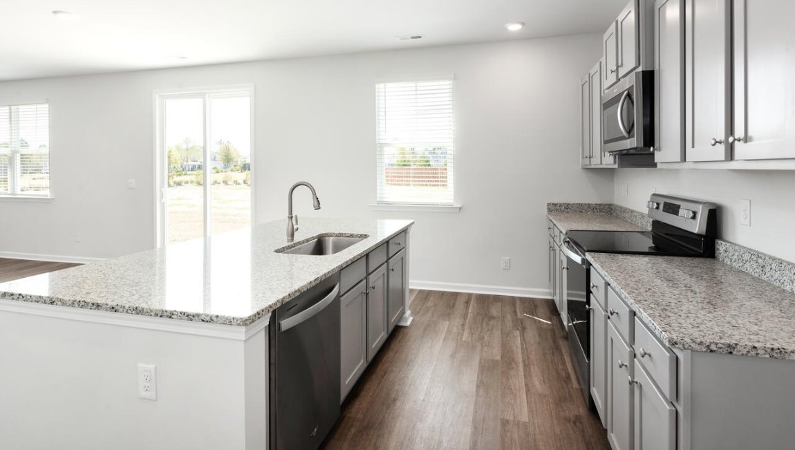 The kitchen features shaker-style cabinets, granite countertops, and stainless-steel appliances, which are sure to both turn heads and make meal prep easy.