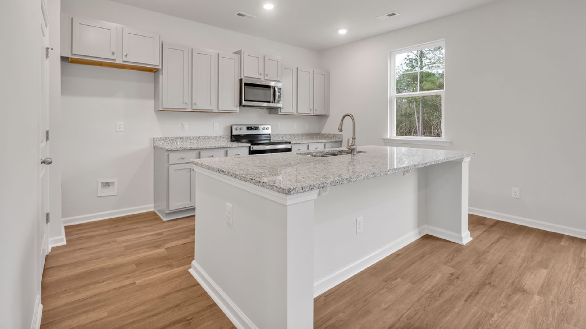 The kitchen features shaker-style cabinets, granite countertops, and stainless-steel appliances, which are sure to both turn heads and make meal prep easy.