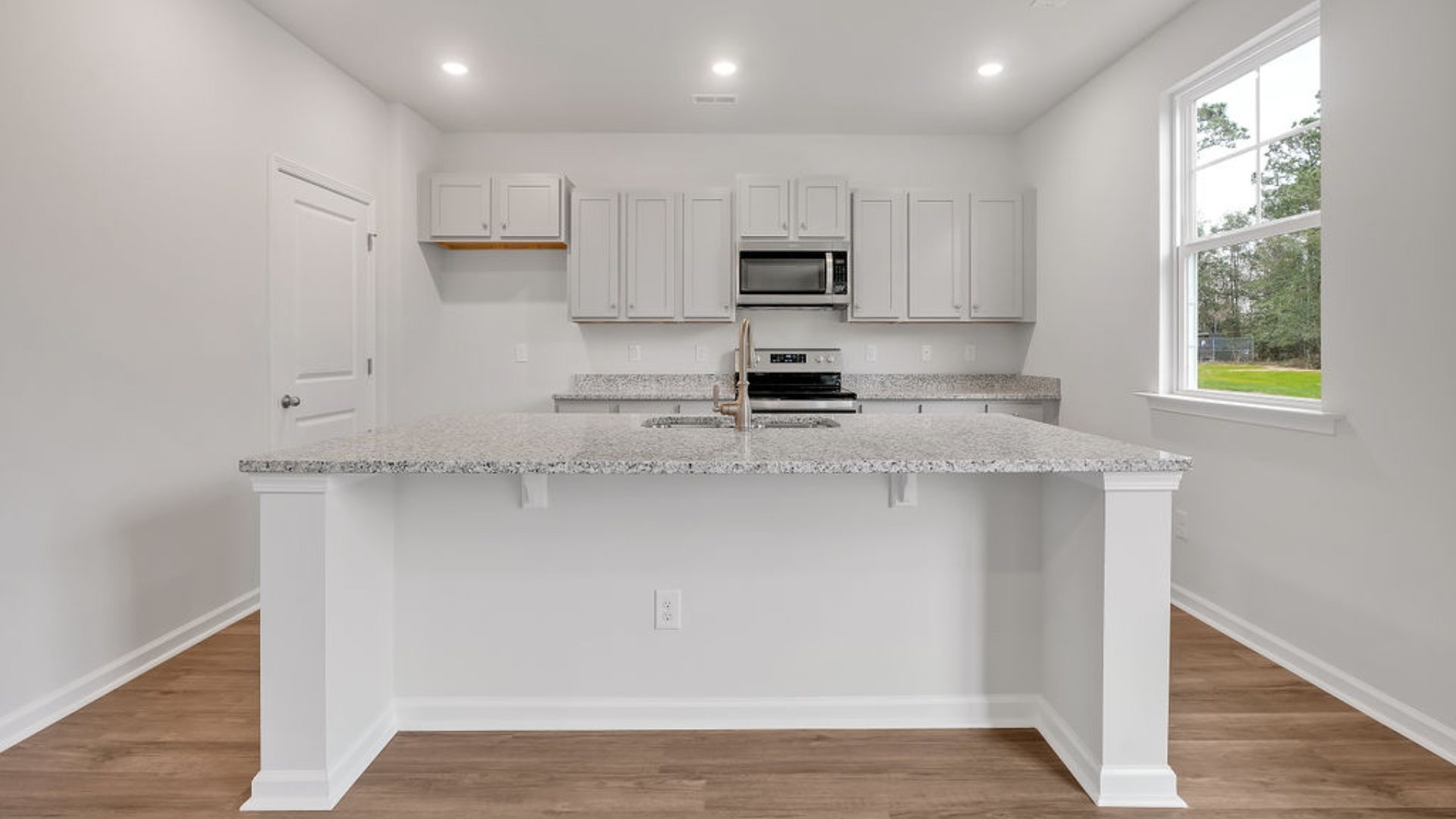 The kitchen features shaker-style cabinets, granite countertops, and stainless-steel appliances, which are sure to both turn heads and make meal prep easy.