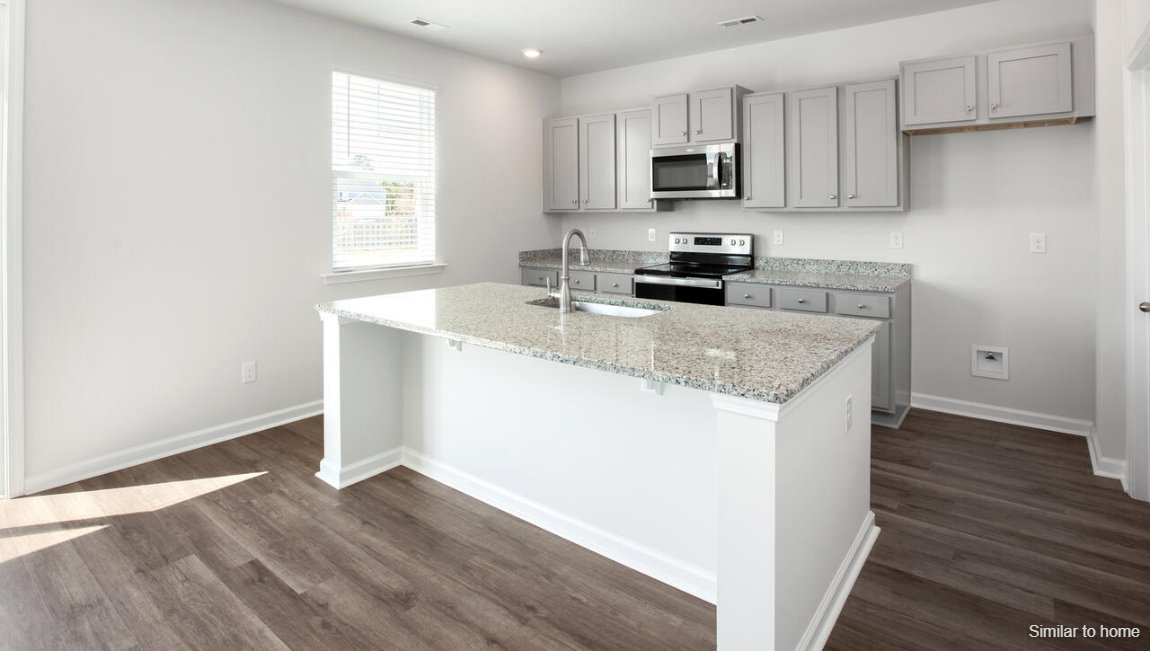 The kitchen features shaker-style cabinets, granite countertops, and stainless-steel appliances, which are sure to both turn heads and make meal prep easy. You’ll never be too far from the action with the living and dining area right there.