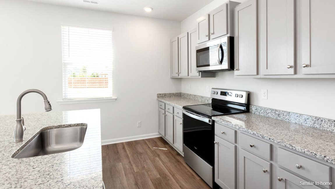 The kitchen features shaker-style cabinets, granite countertops, and stainless-steel appliances, which are sure to both turn heads and make meal prep easy. You’ll never be too far from the action with the living and dining area right there.