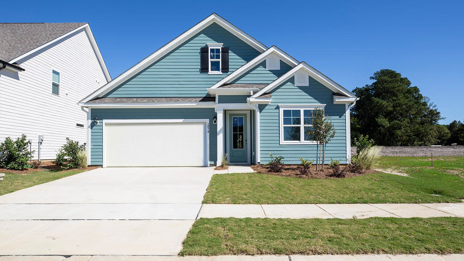 Discover the allure of Grayson Park located in Leland NC. The Litchfield plan is a perfect home for beach living and entertaining. 3 Bedrooms, 2 baths, 2032 sq ft.