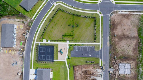 Residents have access to a range of amenities such as a well-equipped clubhouse, a fitness room, a spacious competition swimming pool, a kiddie pool, a hot tub, a sports court, a playground, and picturesque nature trails for walking.
