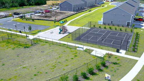 Residents have access to a range of amenities such as a well-equipped clubhouse, a fitness room, a spacious competition swimming pool, a kiddie pool, a hot tub, a sports court, a playground, and picturesque nature trails for walking.