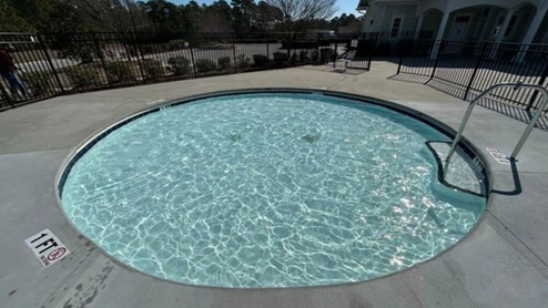 Residents have access to a range of amenities such as a well-equipped clubhouse, a fitness room, a spacious competition swimming pool, a kiddie pool, a hot tub, a sports court, a playground, and picturesque nature trails for walking.