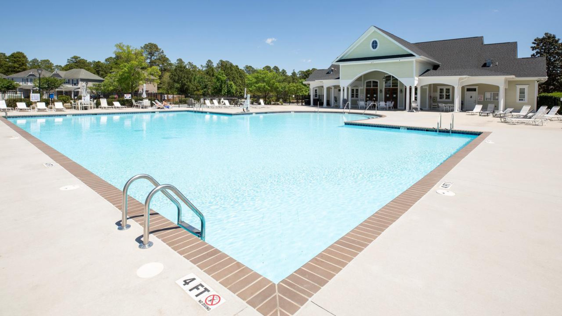 Residents have access to a range of amenities such as a well-equipped clubhouse, a fitness room, a spacious competition swimming pool, a kiddie pool, a hot tub, a sports court, a playground, and picturesque nature trails for walking.