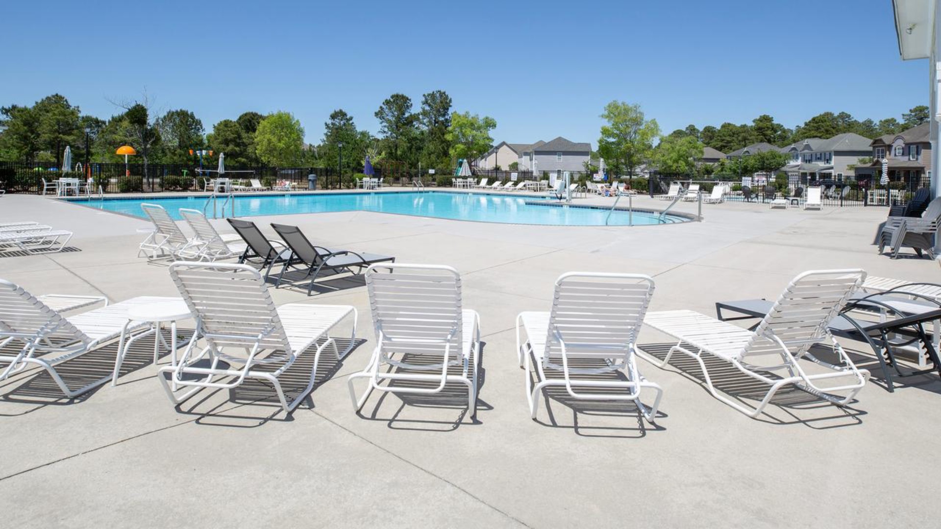 Residents have access to a range of amenities such as a well-equipped clubhouse, a fitness room, a spacious competition swimming pool, a kiddie pool, a hot tub, a sports court, a playground, and picturesque nature trails for walking.