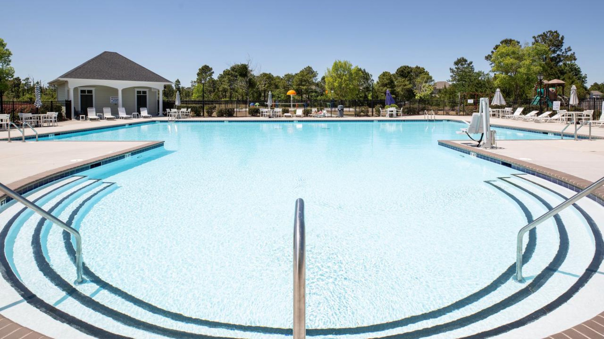 Residents have access to a range of amenities such as a well-equipped clubhouse, a fitness room, a spacious competition swimming pool, a kiddie pool, a hot tub, a sports court, a playground, and picturesque nature trails for walking.