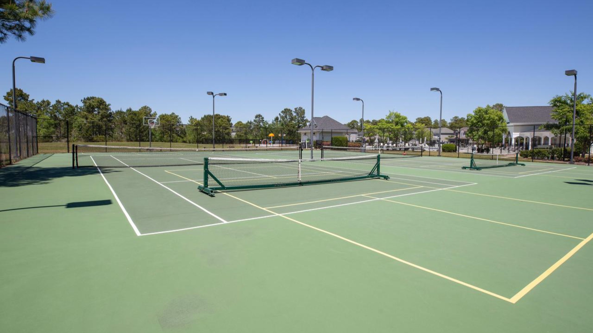 Residents have access to a range of amenities such as a well-equipped clubhouse, a fitness room, a spacious competition swimming pool, a kiddie pool, a hot tub, a sports court, a playground, and picturesque nature trails for walking.