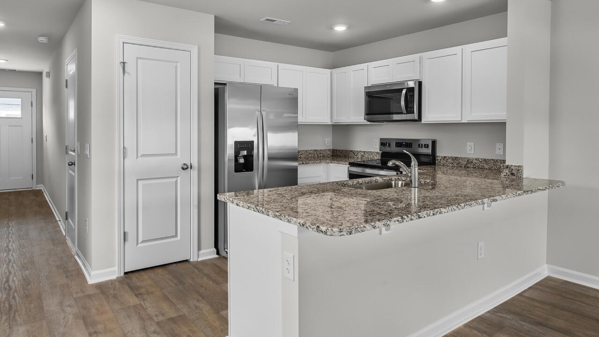 The kitchen is equipped with stainless steel appliances and granite countertops. Additionally