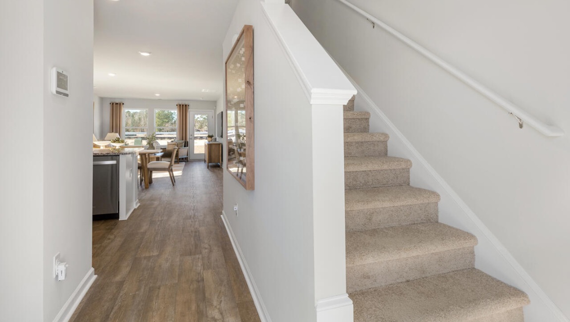 Upstairs, there are 3 more bedrooms, a shared bathroom and a loft area, adding to the flexibility of the layout. For those in search of a contemporary townhome with a functional layout, the Norman is an excellent choice.