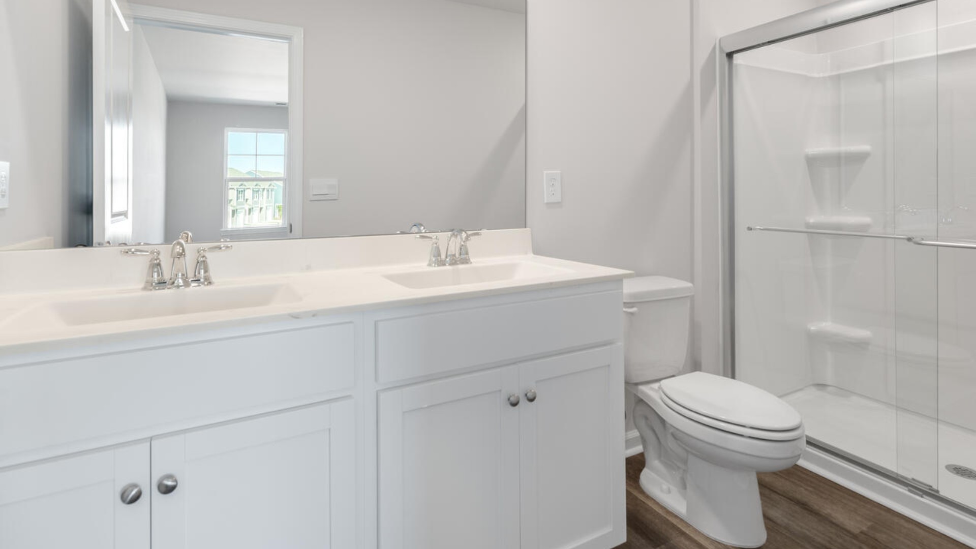 It also includes two additional bedrooms, a shared bathroom, and a laundry room for convenience. The bathrooms are equally elegant, featuring matching granite and a primary suite with a glass shower that feels like your own personal spa