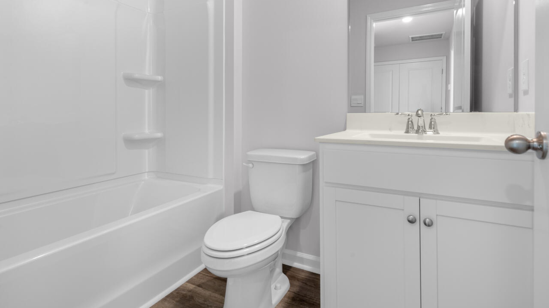 It also includes two additional bedrooms, a shared bathroom, and a laundry room for convenience. The bathrooms are equally elegant, featuring matching granite and a primary suite with a glass shower that feels like your own personal spa