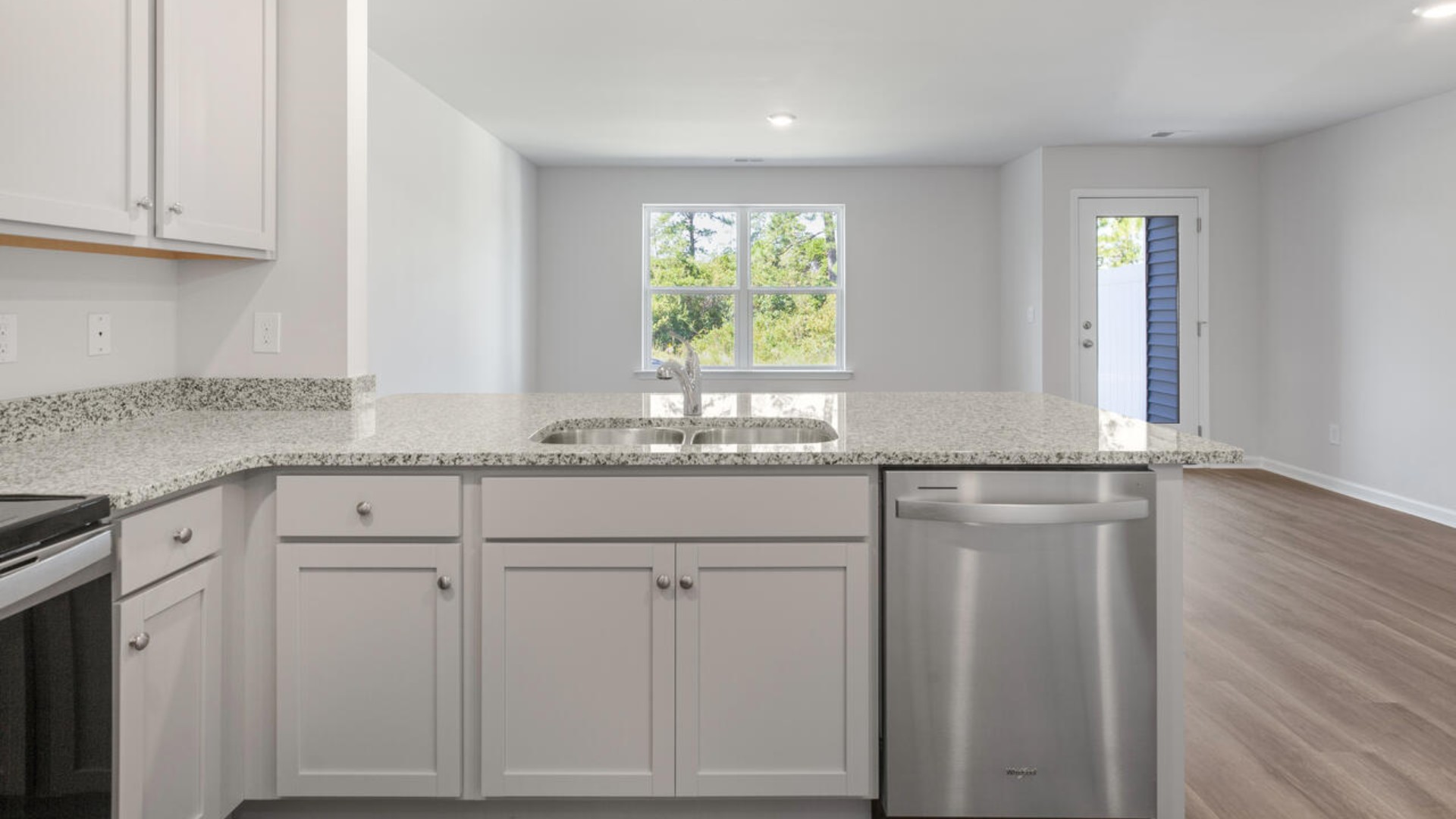 The kitchen overlooks the dining and living spaces, ideal for entertaining guests or enjoying family time while preparing meals with new stainless-steel appliances and Granite countertops.