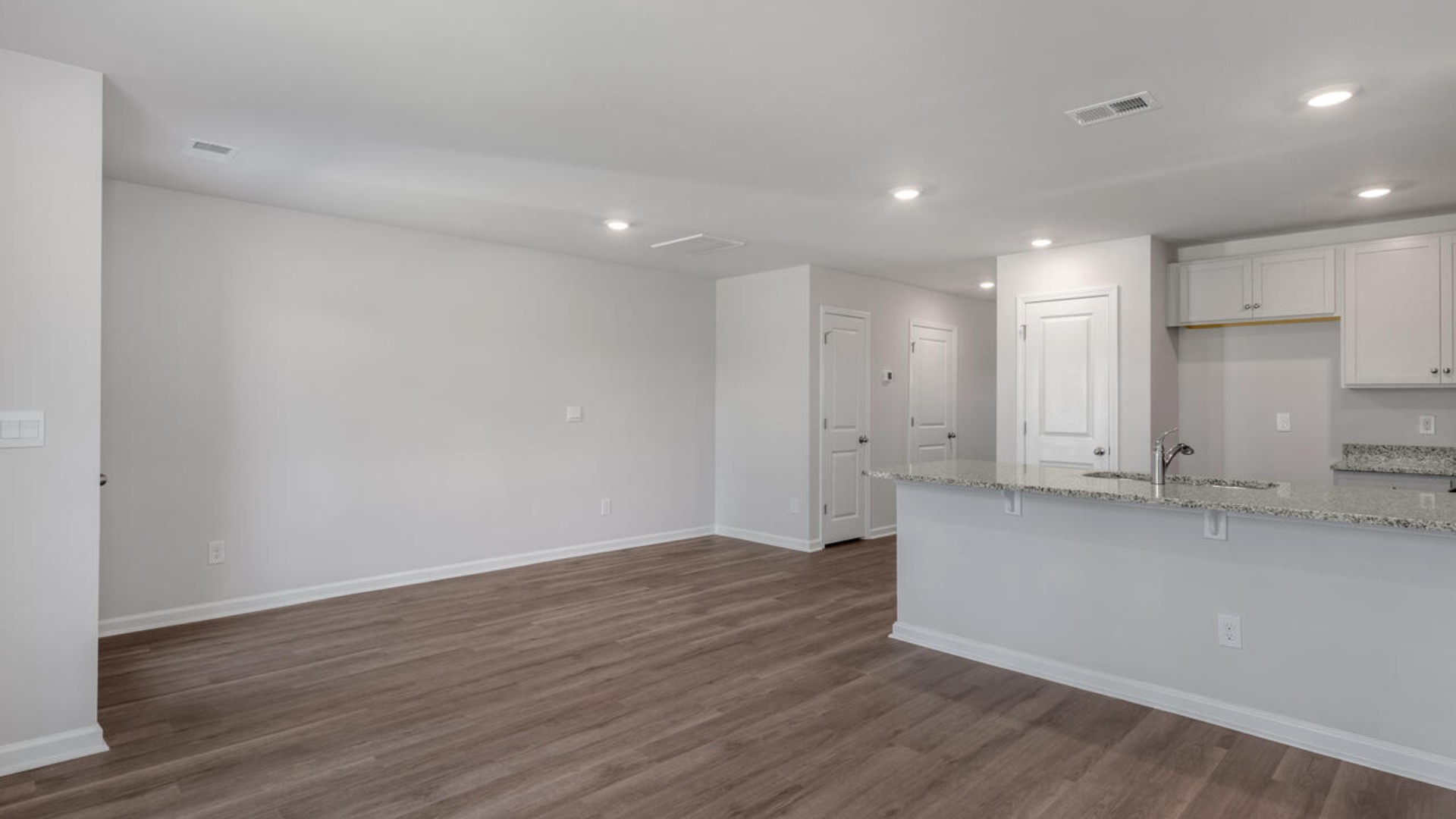 The kitchen overlooks the dining and living spaces, ideal for entertaining guests or enjoying family time while preparing meals with new stainless-steel appliances and Granite countertops.
