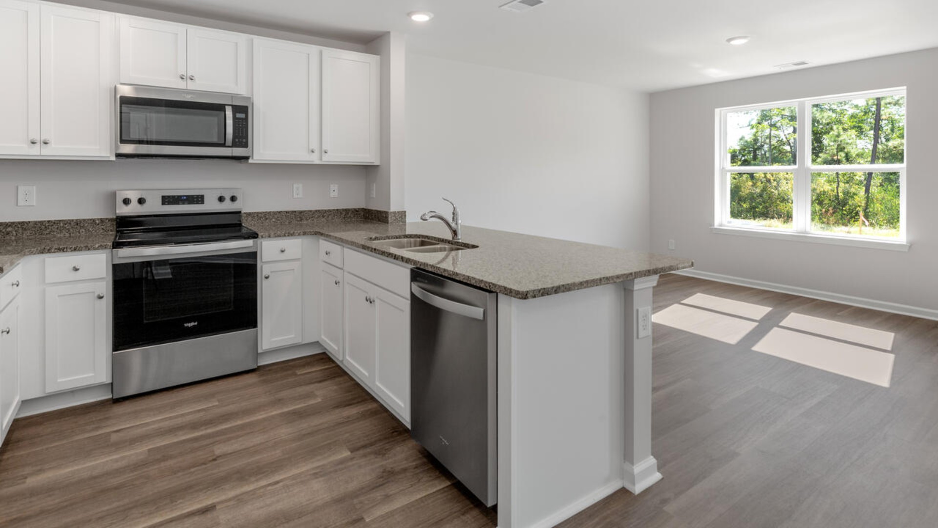 The kitchen overlooks the dining and living spaces, ideal for entertaining guests or enjoying family time while preparing meals with new stainless-steel appliances and Granite countertops. There is a half bath on the first floor.