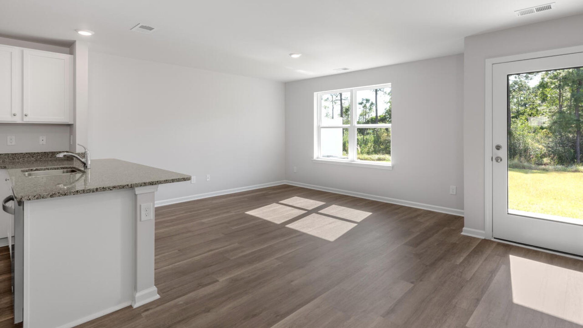 The kitchen overlooks the dining and living spaces, ideal for entertaining guests or enjoying family time