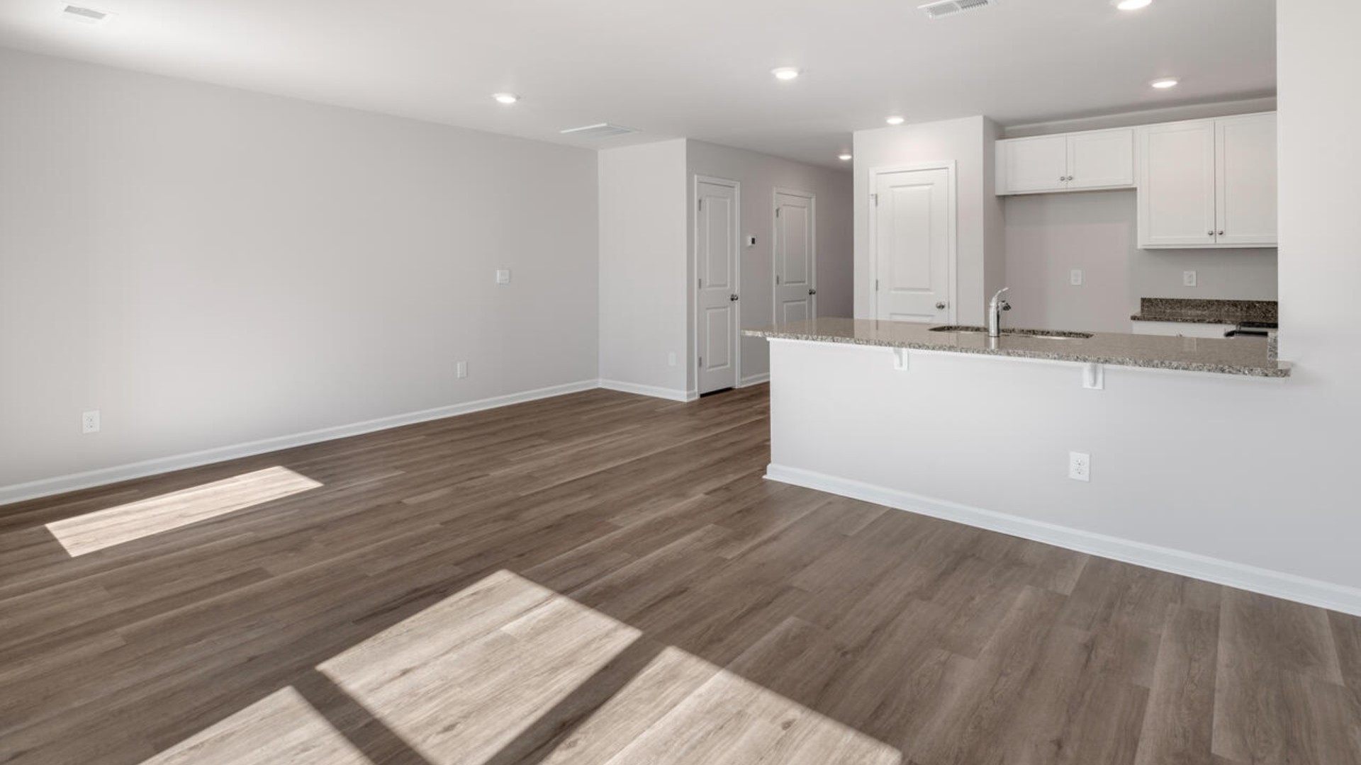 The kitchen overlooks the dining and living spaces, ideal for entertaining guests or enjoying family time while preparing meals