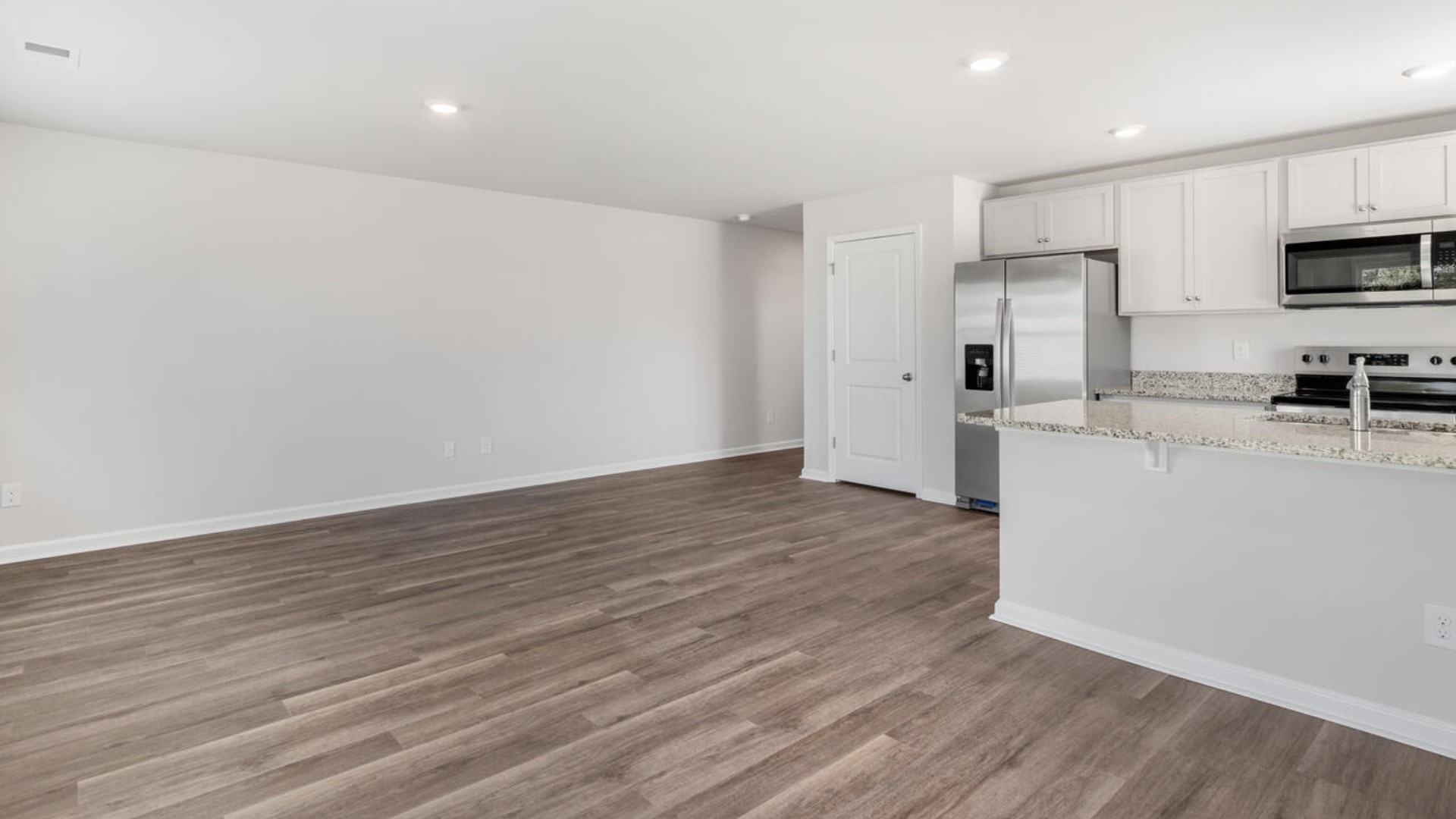 Your new Mitchell features an open concept first floor anchored by a spacious kitchen with a peninsula bar that overlooks your family and dining room