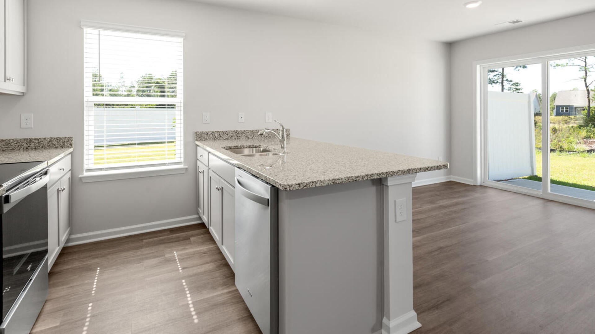 The kitchen features shaker-style cabinets, granite countertops, and stainless steel appliances, which are sure to both turn heads and make meal prep easy.