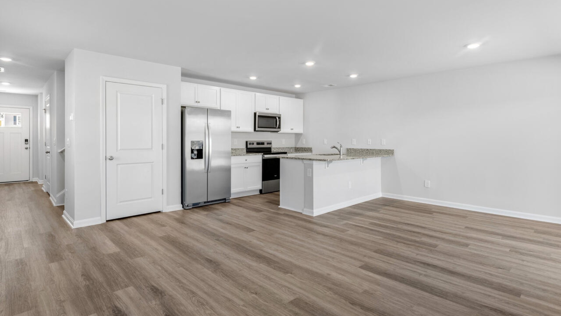 The kitchen features shaker-style cabinets, granite countertops, and stainless steel appliances, which are sure to both turn heads and make meal prep easy.