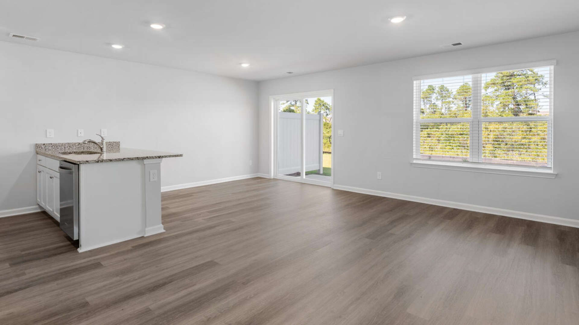 The kitchen features shaker-style cabinets, granite countertops, and stainless steel appliances, which are sure to both turn heads and make meal prep easy. You’ll never be too far from the action with the living and dining area right there.