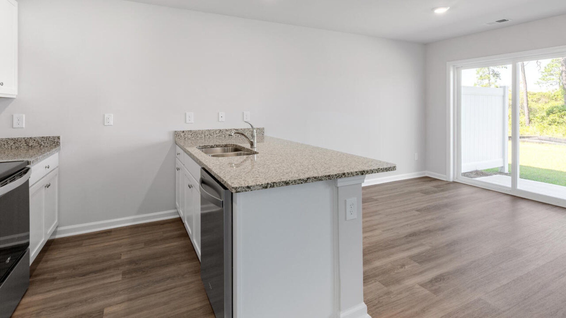 The kitchen features shaker-style cabinets, granite countertops, and stainless steel appliances, which are sure to both turn heads and make meal prep easy. You’ll never be too far from the action with the living and dining area right there.