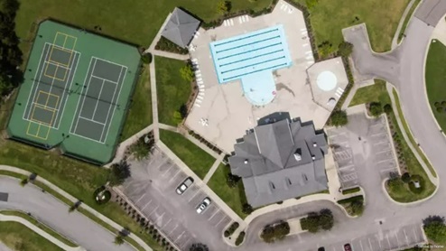 Residents have access to a range of amenities such as a well-equipped clubhouse, a fitness room, a spacious competition swimming pool, a kiddie pool, a hot tub, a sports court, a playground, and picturesque nature trails for walking.