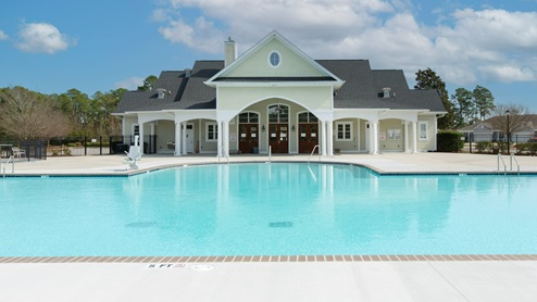 Residents have access to a range of amenities such as a well-equipped clubhouse, a fitness room, a spacious competition swimming pool, a kiddie pool, a hot tub, a sports court, a playground, and picturesque nature trails for walking.