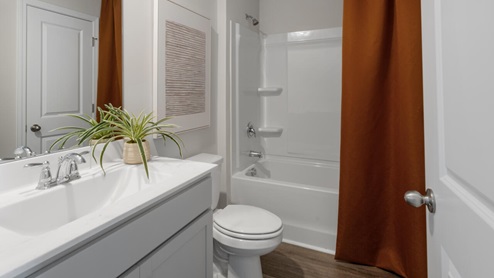two additional bedrooms, a shared bathroom, and a laundry room.