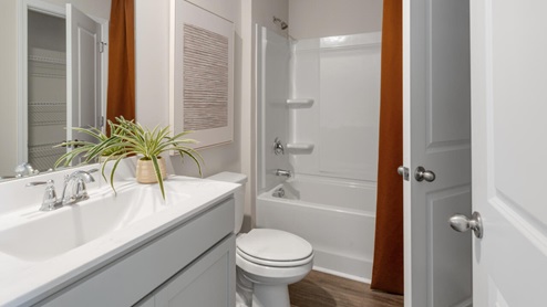 two additional bedrooms, a shared bathroom, and a laundry room.