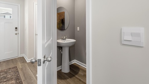 The Mitchell is a two-story townhome featuring 4 bedrooms, 2.5 baths. The first floor offers a spacious kitchen that opens into an airy living area