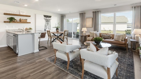The Mitchell is a two-story townhome featuring 4 bedrooms, 2.5 baths. The first floor offers a spacious kitchen that opens into an airy living area, ideal for entertaining.