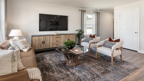 The Mitchell is a two-story townhome featuring 4 bedrooms, 2.5 baths. The first floor offers a spacious kitchen that opens into an airy living area, ideal for entertaining.