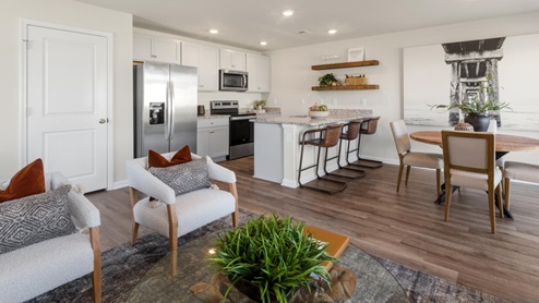 The Mitchell is a two-story townhome featuring 4 bedrooms, 2.5 baths. The first floor offers a spacious kitchen that opens into an airy living area, ideal for entertaining.