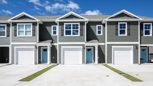 The Mitchell is a two-story townhome featuring 4 bedrooms, 2.5 baths. The first floor offers a spacious kitchen that opens into an airy living area
