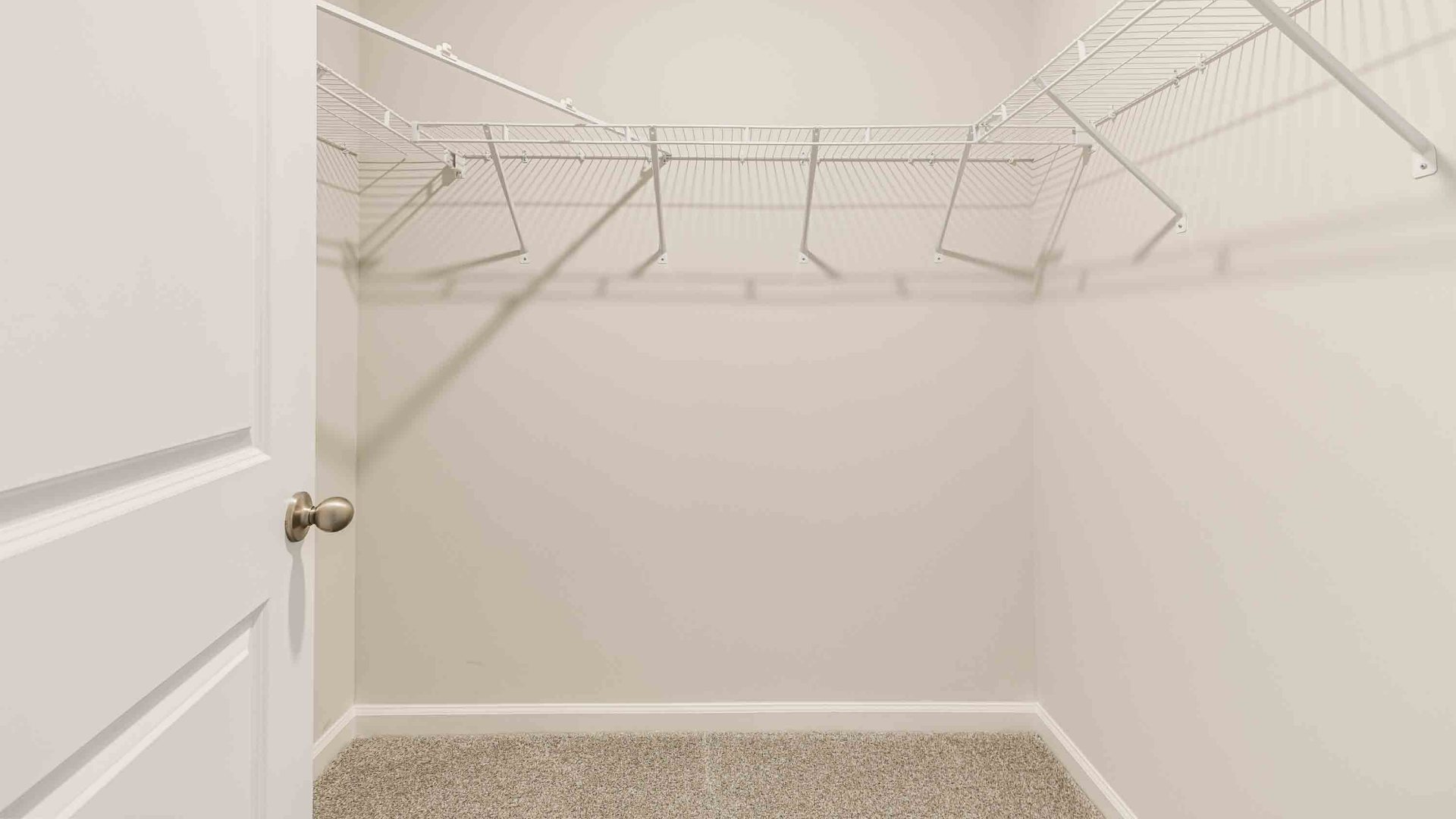 The primary suite is tucked away in the back of the home, offering a peaceful retreat complete with a walk-in shower, granite vanity, and a roomy walk-in closet.